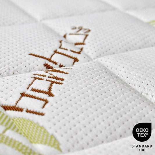 Close-up of a mattress with 'Mylux' branding and OEKO-TEX Standard 100 logo.