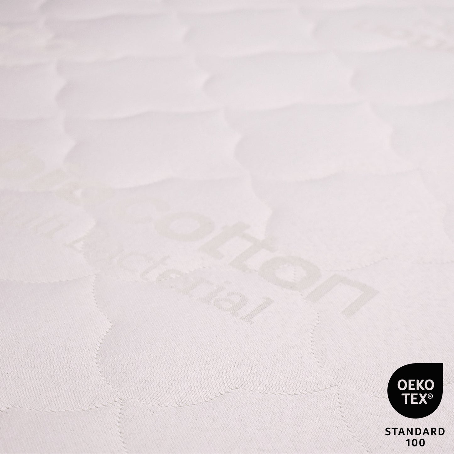Close-up of a textured white fabric with 'Kotton' branding and OEKO-TEX Standard 100 logo.