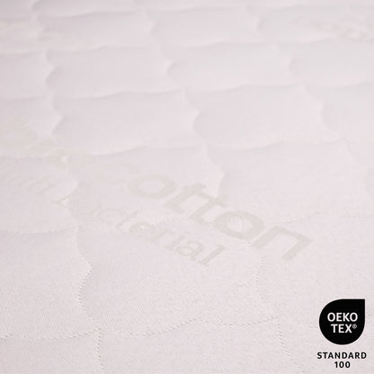 Close-up of a textured white fabric with 'Kotton' branding and OEKO-TEX Standard 100 logo.