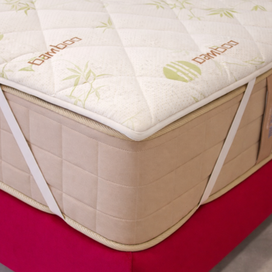 Mattress with 'Bamboo' branding on a red surface